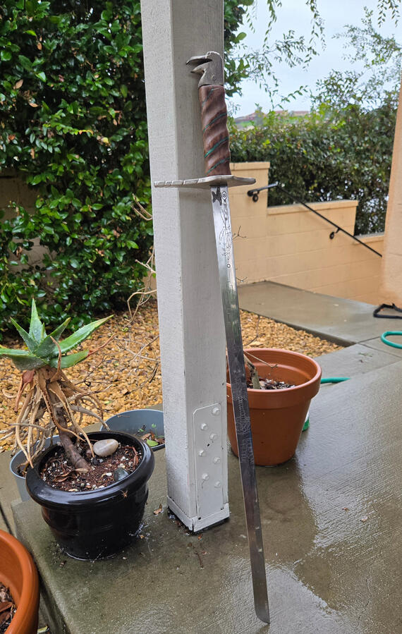 Corax, Crow Sword. Etched blade, nickel-plated brass crossguard and pommel, walnut and malachite grip.